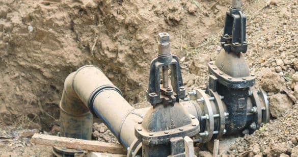 Backflow prevention valve installed in an outdoor trench